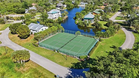 an aerial view of a house with a yard and outdoor seating