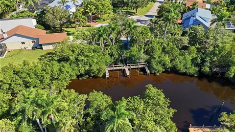 an aerial view of a pool yard and outdoor seating