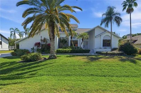 a front view of house with yard and swimming pool