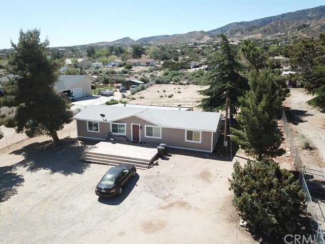 an aerial view of a house with yard patio and balcony