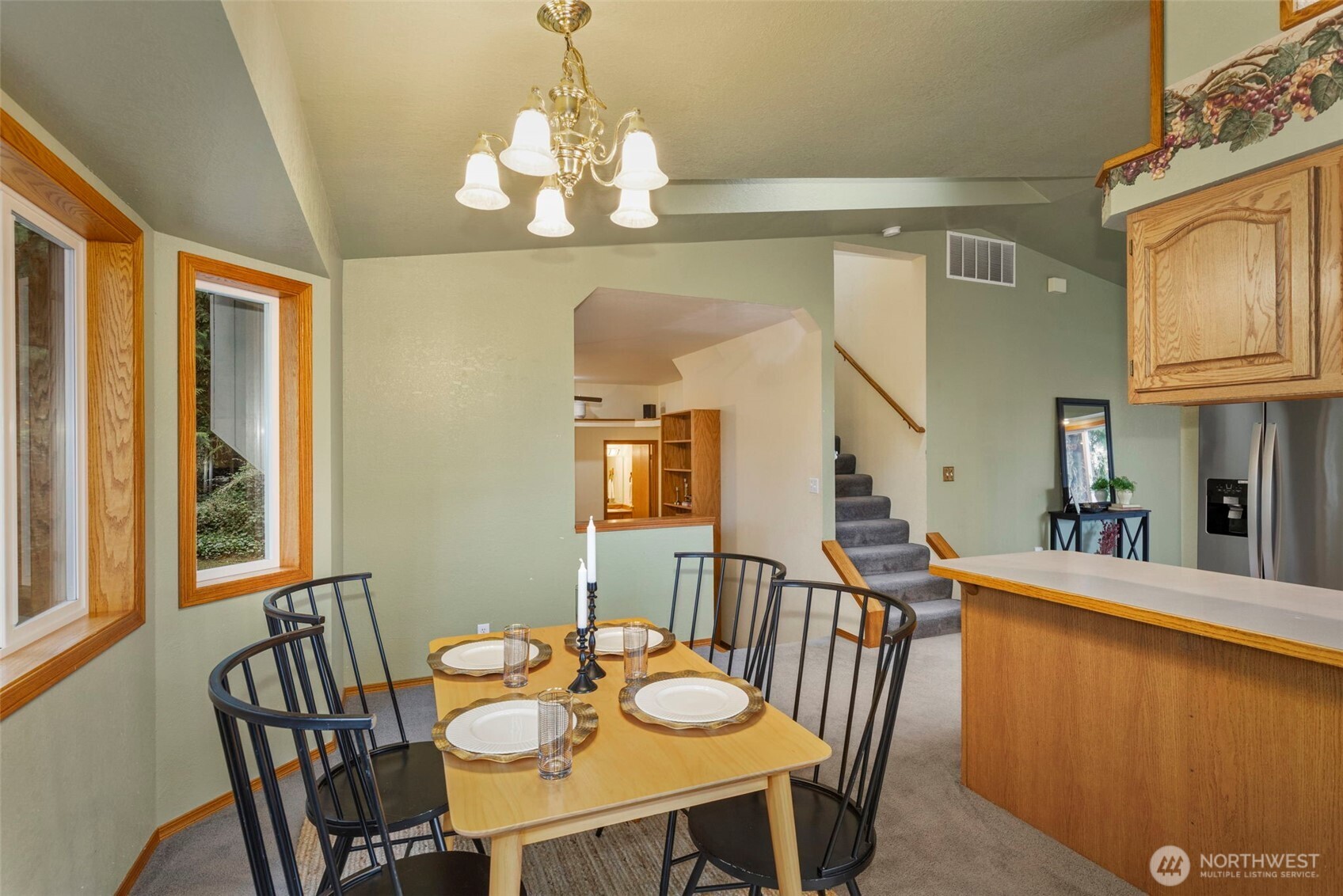 26388 Ansell Road Northwest Poulsbo, WA 98370 - Photo 12 of 37 a view of a dining room with furniture a chandelier and wooden floor