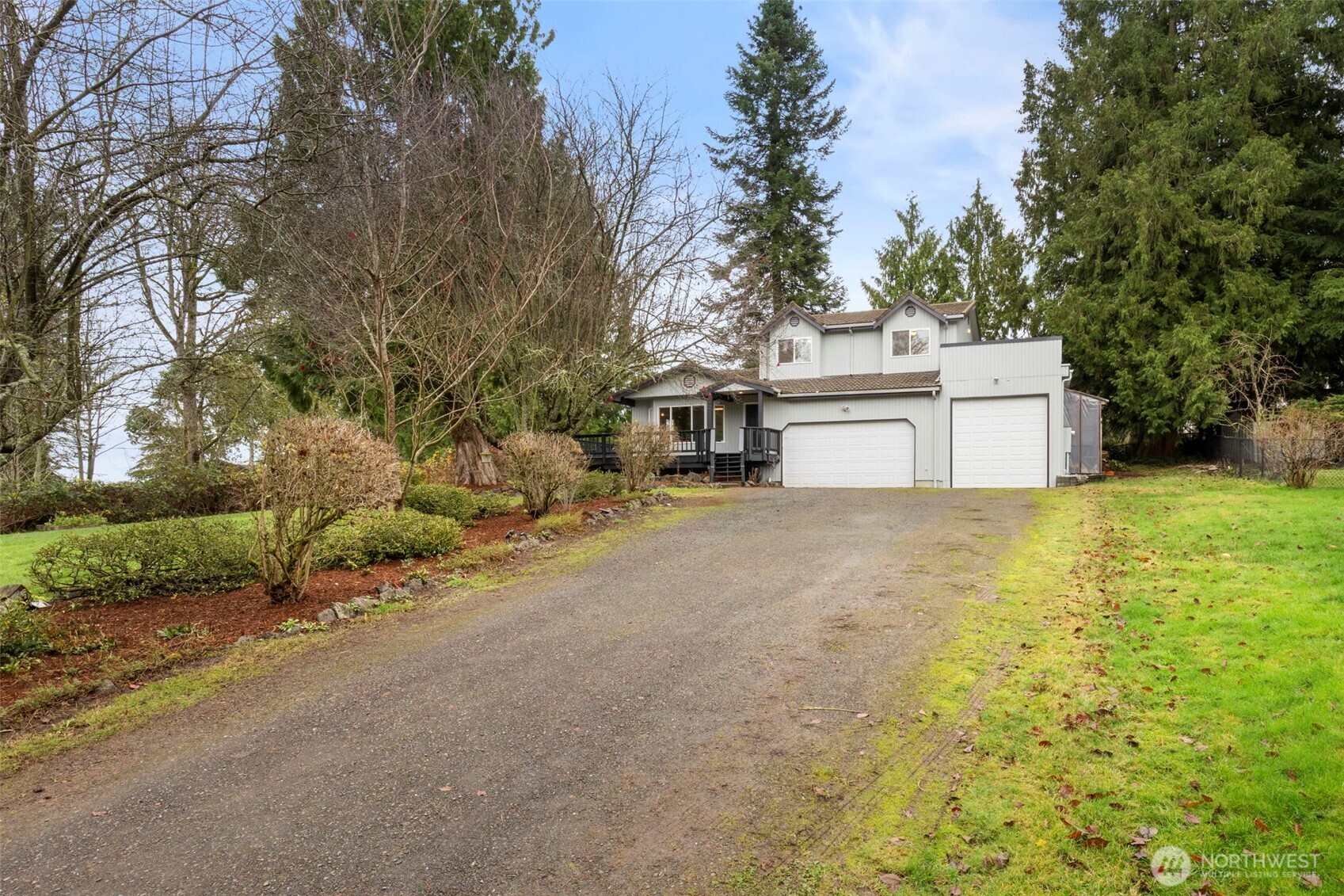 26388 Ansell Road Northwest Poulsbo, WA 98370 - Photo 2 of 37 a view of a small space in front of a house with large trees