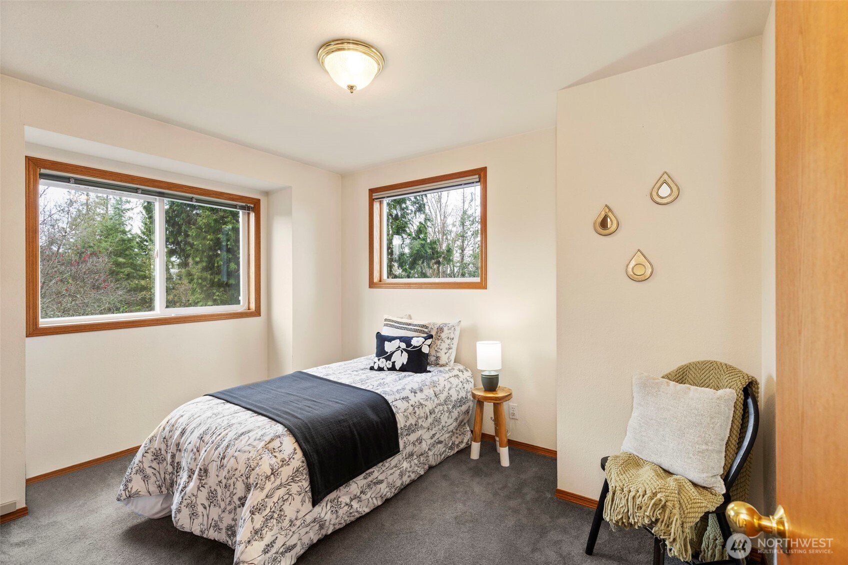 26388 Ansell Road Northwest Poulsbo, WA 98370 - Photo 24 of 37 a bedroom with a bed chair and two windows