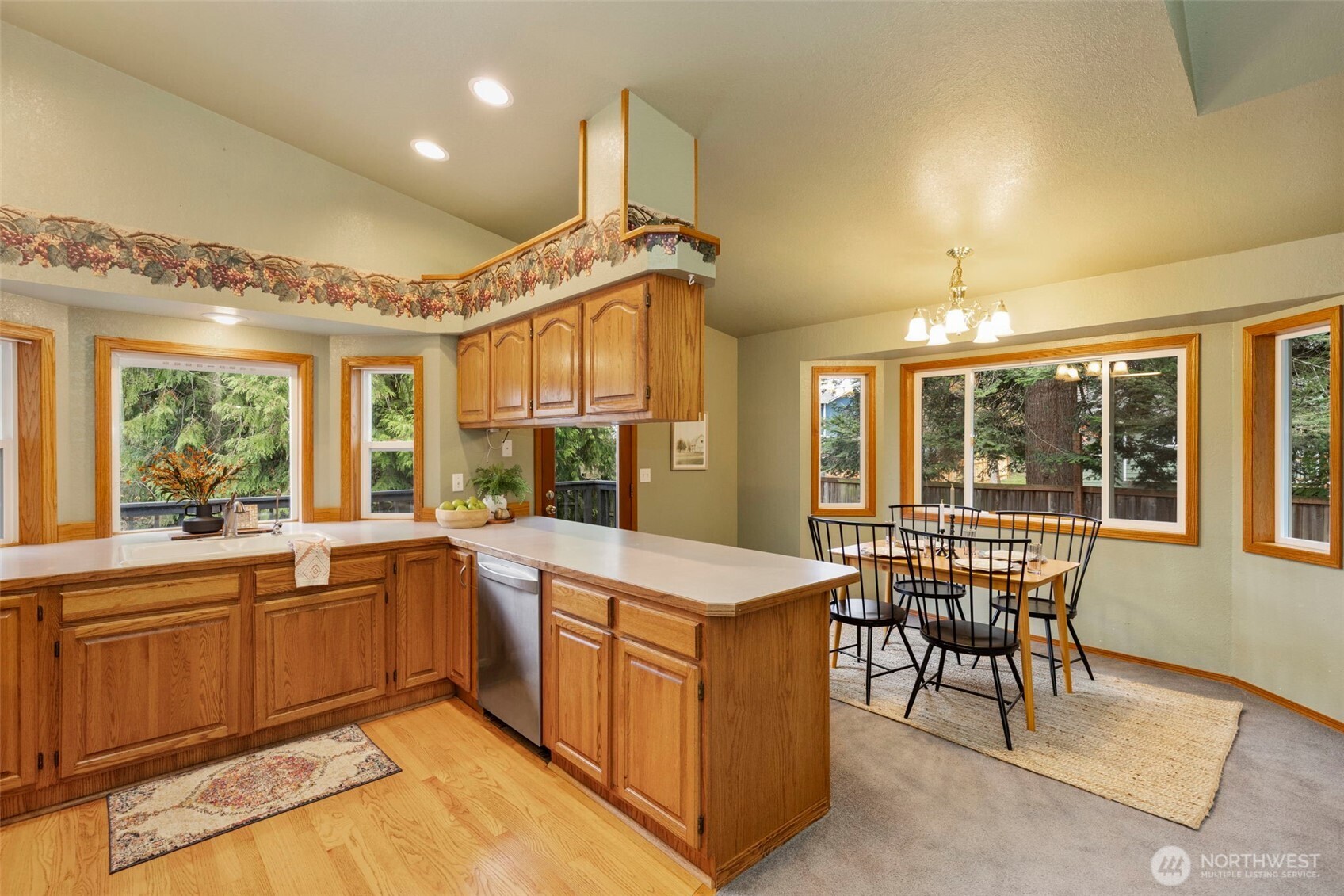 26388 Ansell Road Northwest Poulsbo, WA 98370 - Photo 9 of 37 a kitchen with sink a stove and chairs