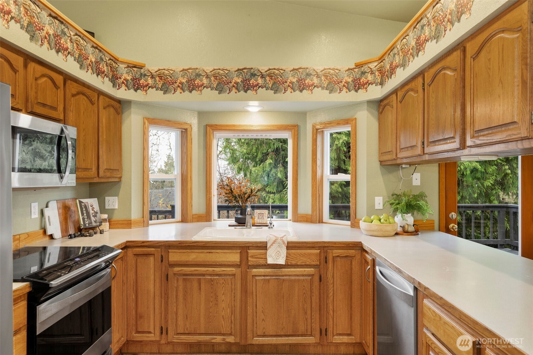 26388 Ansell Road Northwest Poulsbo, WA 98370 - Photo 10 of 37 a kitchen with cabinets appliances and a large window