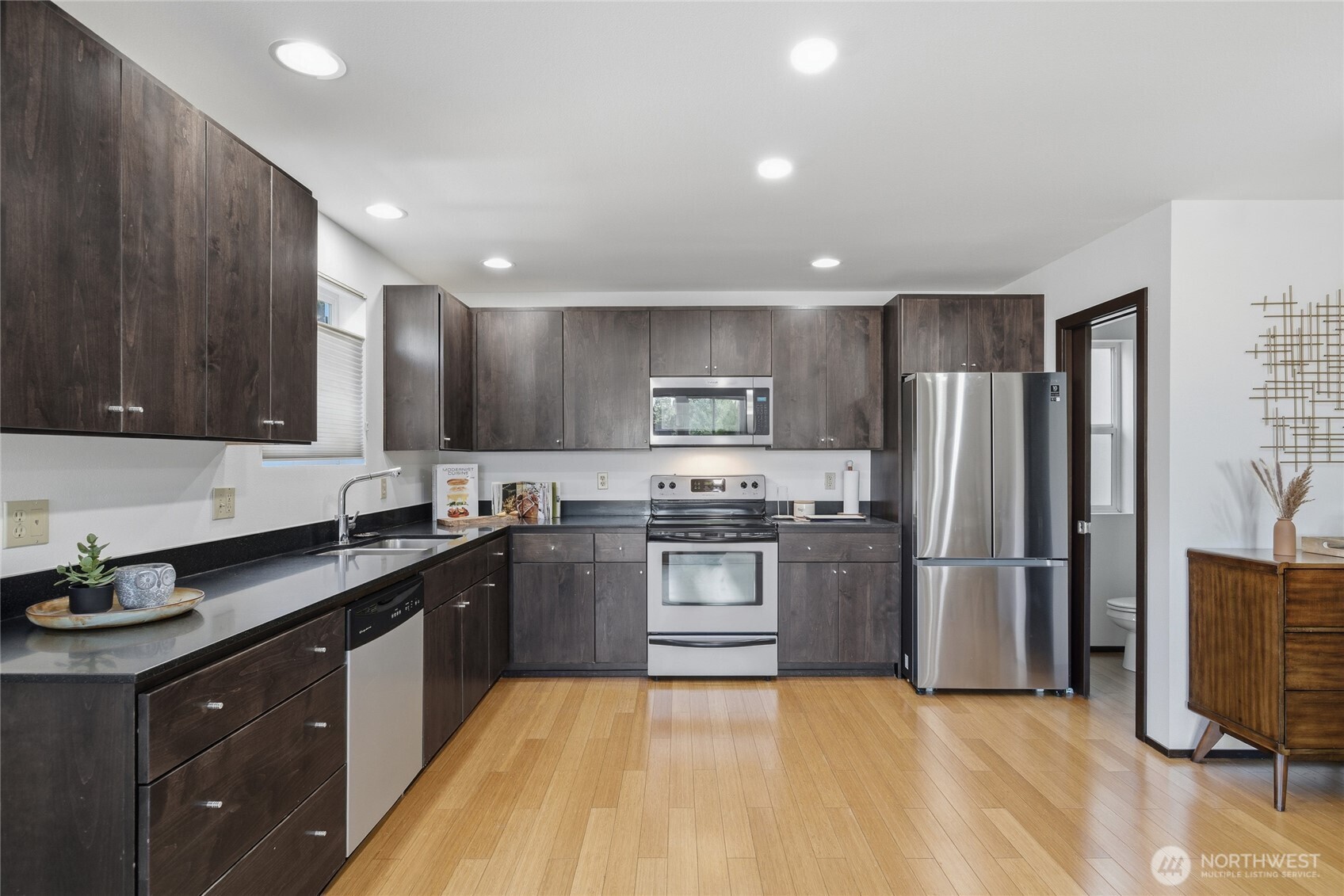8408 Delridge Way Southwest, Unit A Seattle, WA 98106 - Photo 6 of 22 a kitchen with stainless steel appliances granite countertop a sink stove and refrigerator