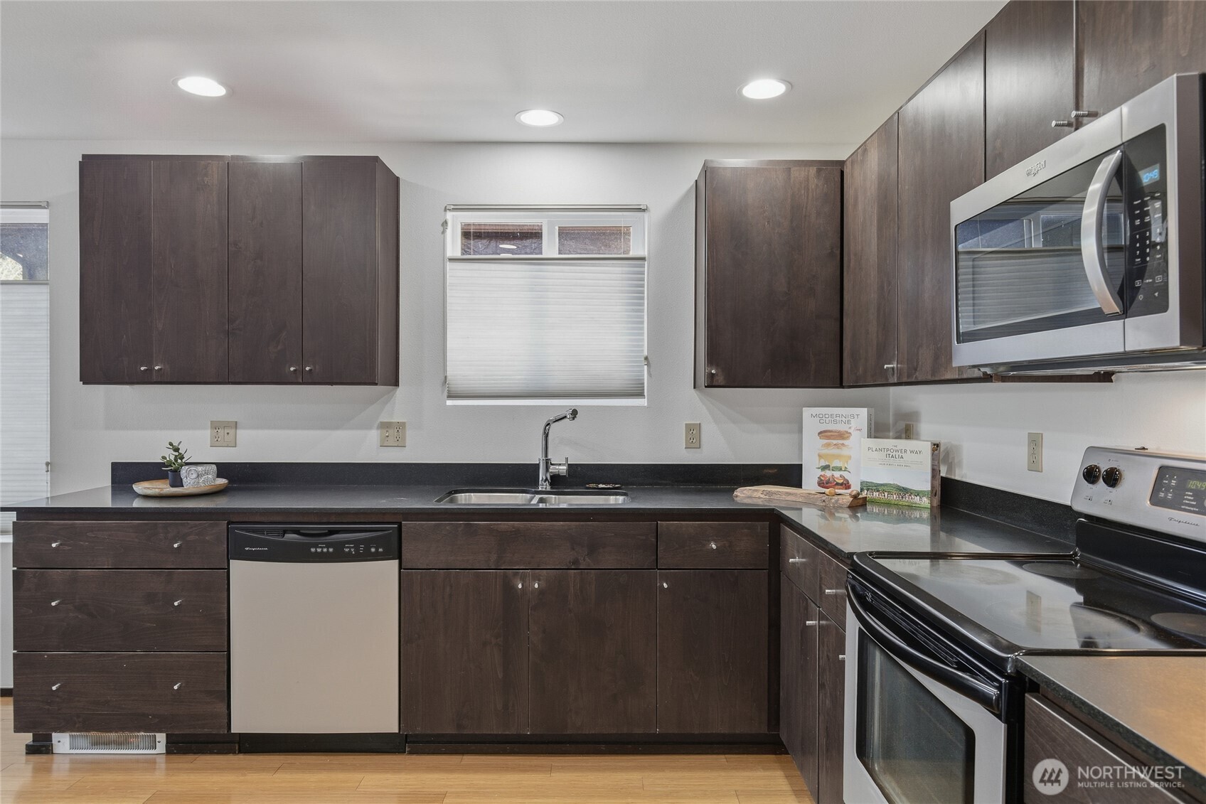8408 Delridge Way Southwest, Unit A Seattle, WA 98106 - Photo 7 of 22 a kitchen with stainless steel appliances granite countertop a sink stove and cabinets