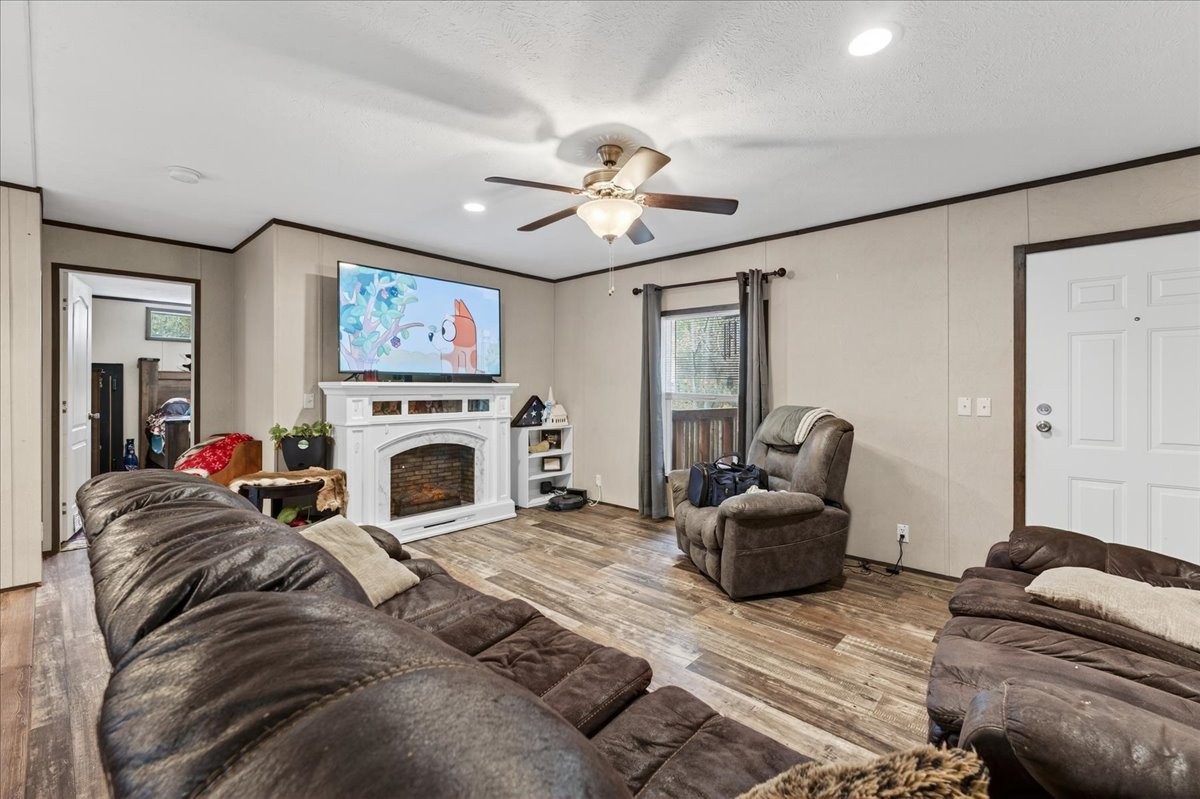 a living room with furniture a fireplace and a flat screen tv