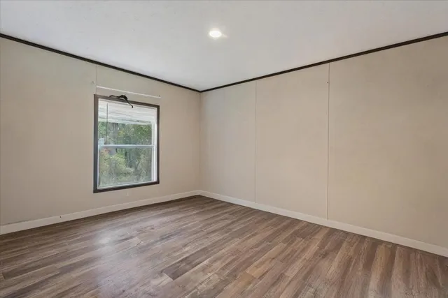 a bedroom with bed and a window