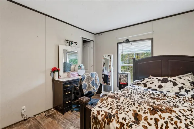 a bed sitting in a bedroom next to a window