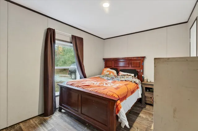 a bedroom with a bed and a dresser