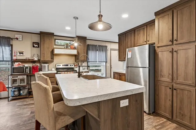 a kitchen with granite countertop a stove and a refrigerator