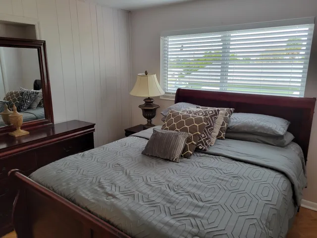 a bedroom with a bed and a dresser