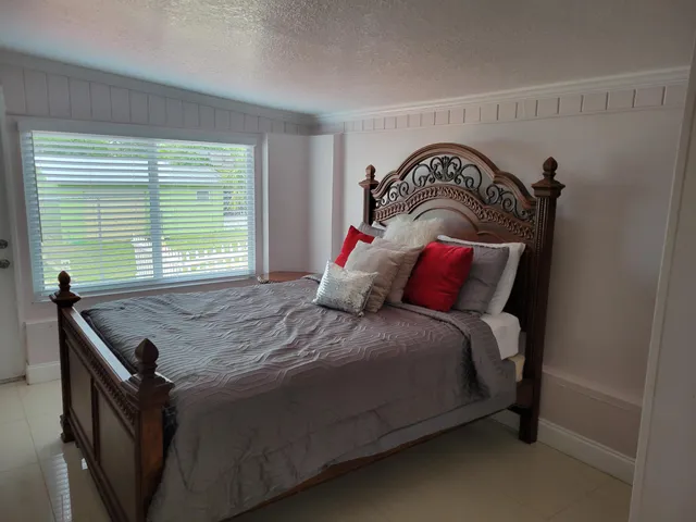 a bedroom with a bed and window