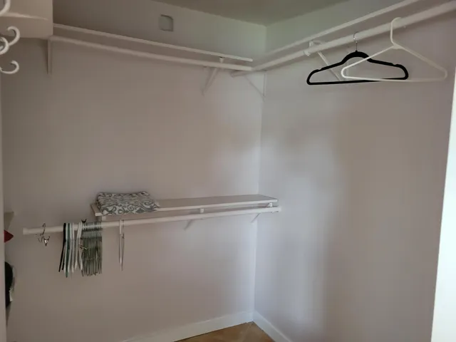 a view of a house with wooden fence