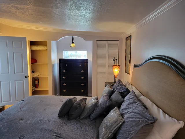 a living room with a bed and a lamp