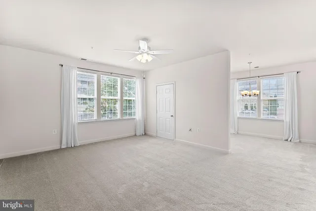 an empty room with windows and closet