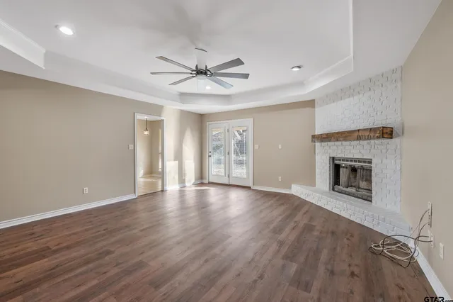 a view of an empty room with a fireplace and a window