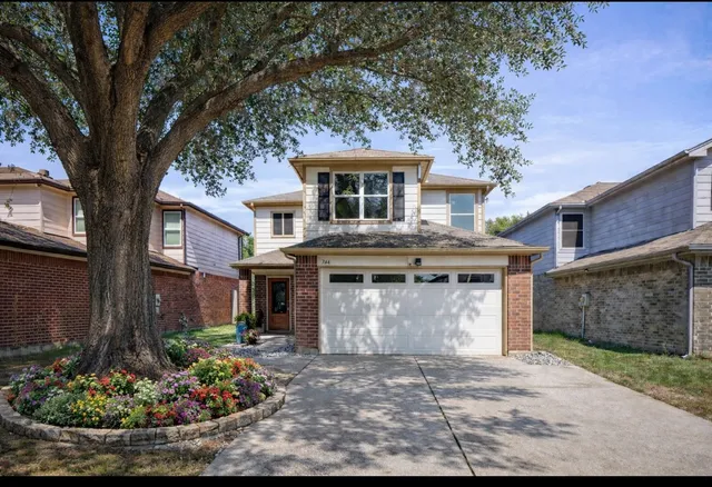 front view of a house with a garden