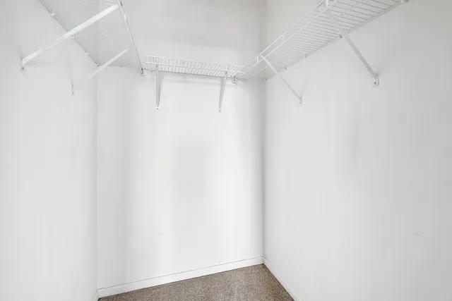 a room with a book shelf and a couch