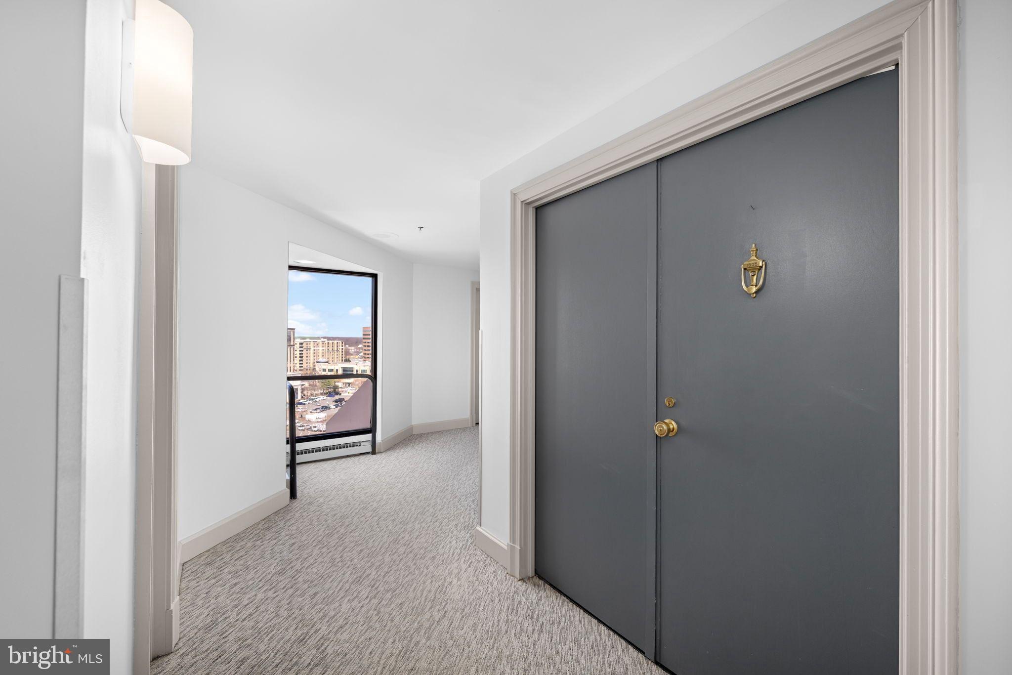 1301 North Courthouse Road, Unit 1805 Arlington, VA 22201 - Photo 8 of 40 a view of a hallway with wooden floor and closet