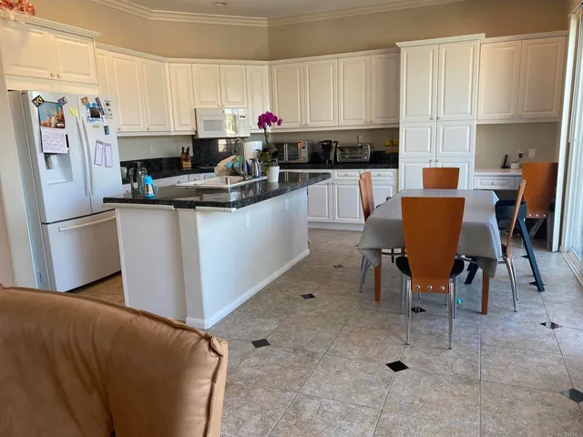 a kitchen with stainless steel appliances granite countertop a refrigerator sink and cabinets