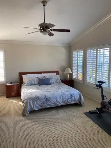 a bedroom with a large bed and a chandelier