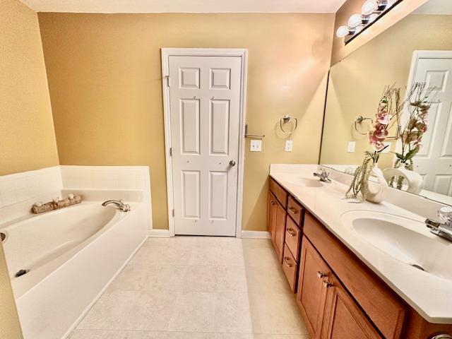 9801 Blackwell Drive Raleigh, NC 27617 - Photo 18 of 23 a bathroom with a sink a tub and a mirror