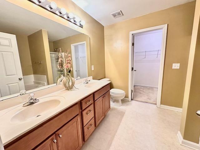 9801 Blackwell Drive Raleigh, NC 27617 - Photo 20 of 23 a spacious bathroom with a double vanity sink a large mirror and a shower