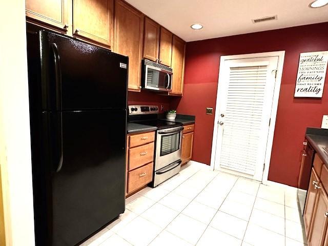 9801 Blackwell Drive Raleigh, NC 27617 - Photo 8 of 23 a kitchen with stainless steel appliances a refrigerator and a stove top oven