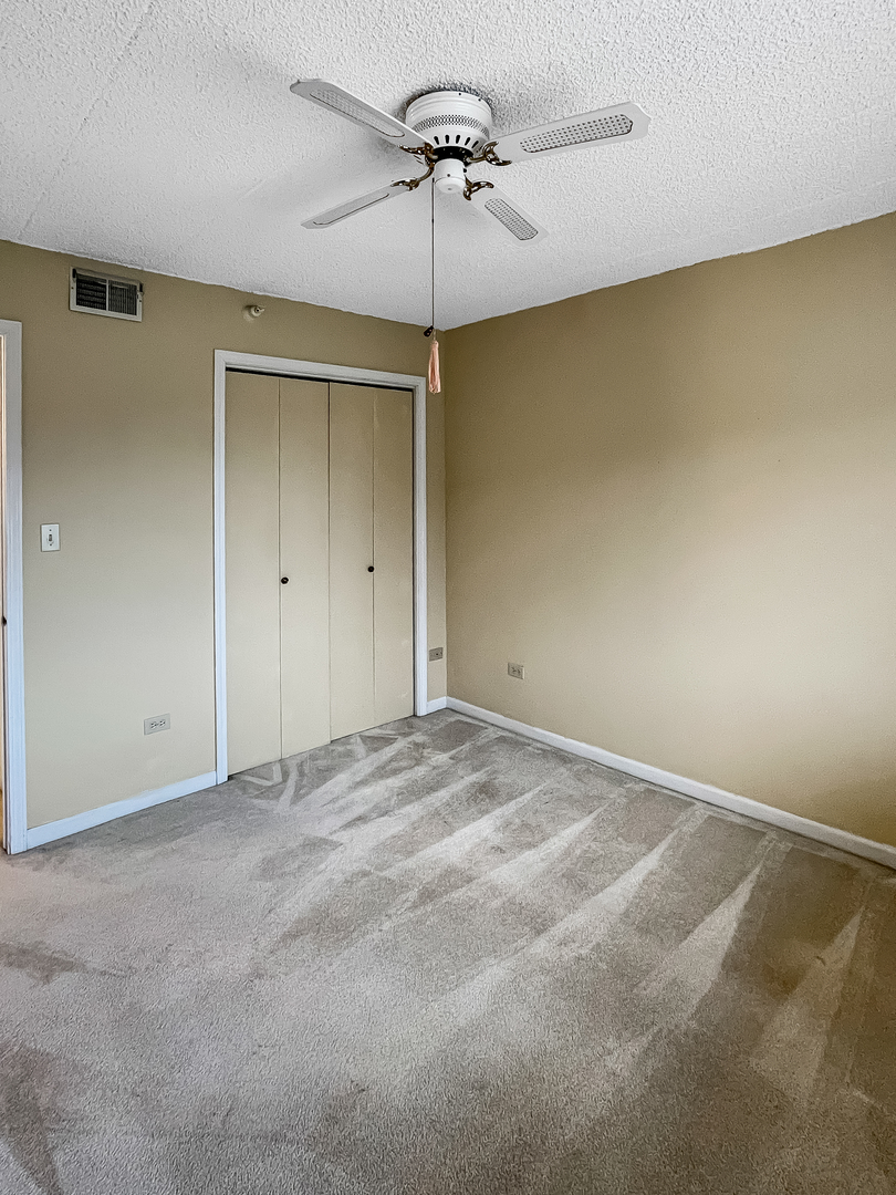 3640 186th Street, Unit 201 Lansing, IL 60438 - Photo 16 of 21 a view of a livingroom with a chandelier fan