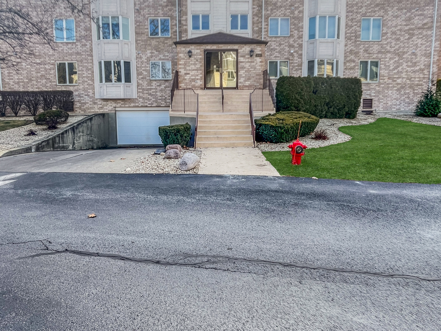 3640 186th Street, Unit 201 Lansing, IL 60438 - Photo 2 of 21 a view of a house with a yard and a garage