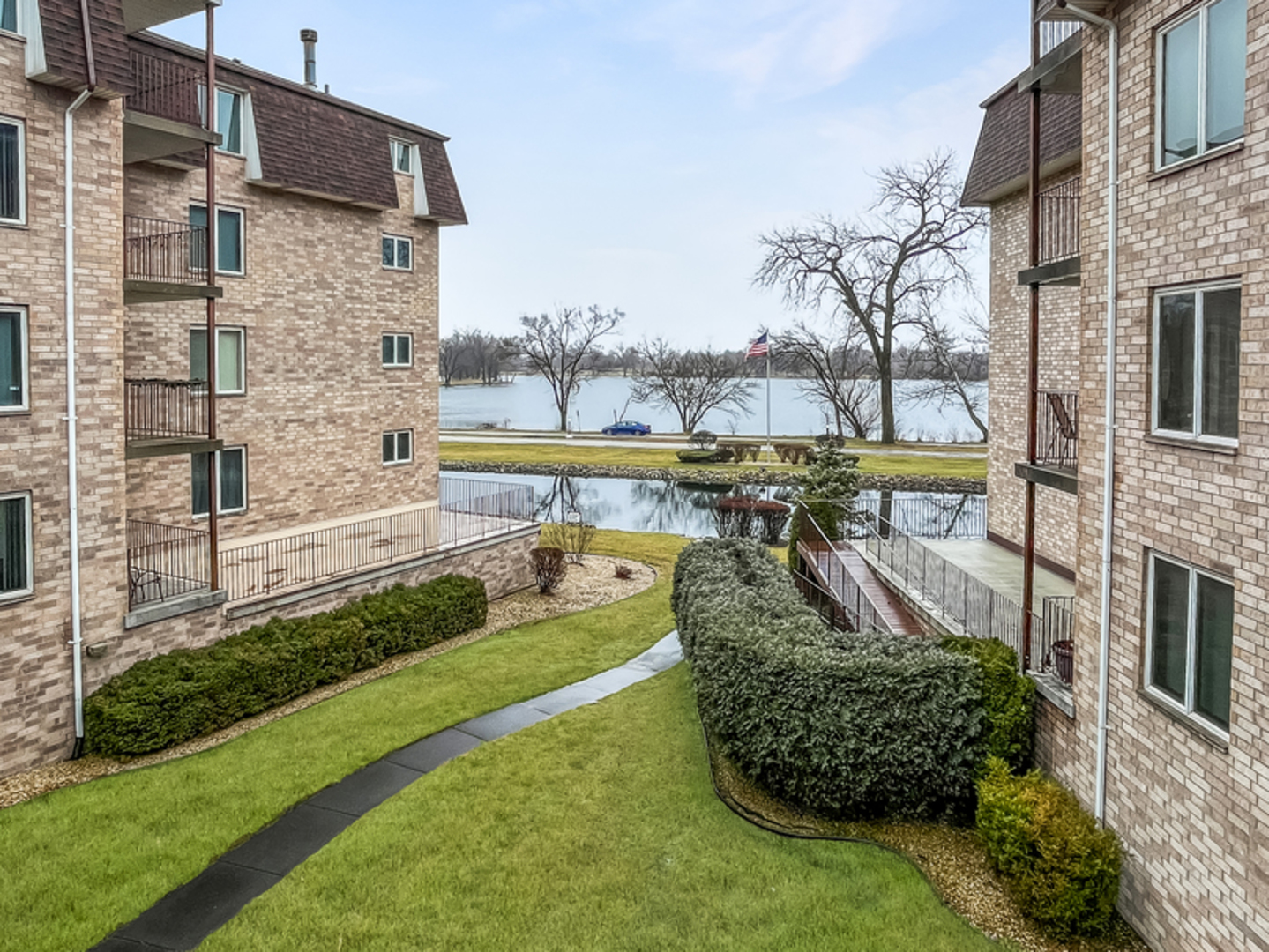 3640 186th Street, Unit 201 Lansing, IL 60438 - Photo 21 of 21 a view of a swimming pool with a garden and plants