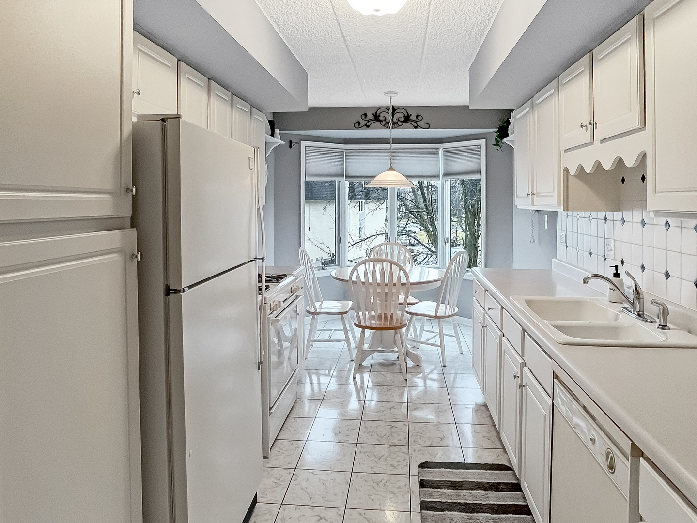 3640 186th Street, Unit 201 Lansing, IL 60438 - Photo 7 of 21 a kitchen with stainless steel appliances a refrigerator a table and chairs