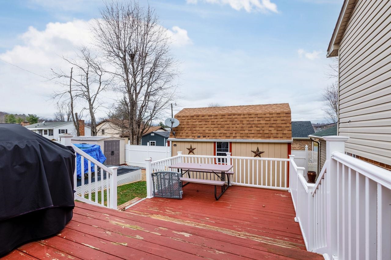 58 Rolla Mill Road Verona, VA 24482 - Photo 16 of 46 a roof deck with table and chairs and wooden floor