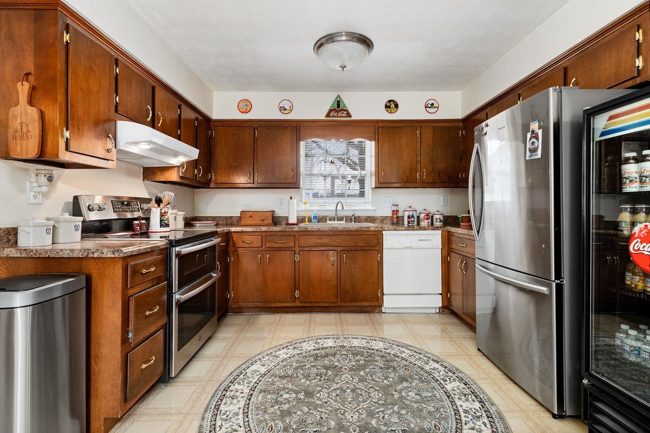 58 Rolla Mill Road Verona, VA 24482 - Photo 27 of 46 a kitchen with stainless steel appliances granite countertop a stove a sink dishwasher and a refrigerator