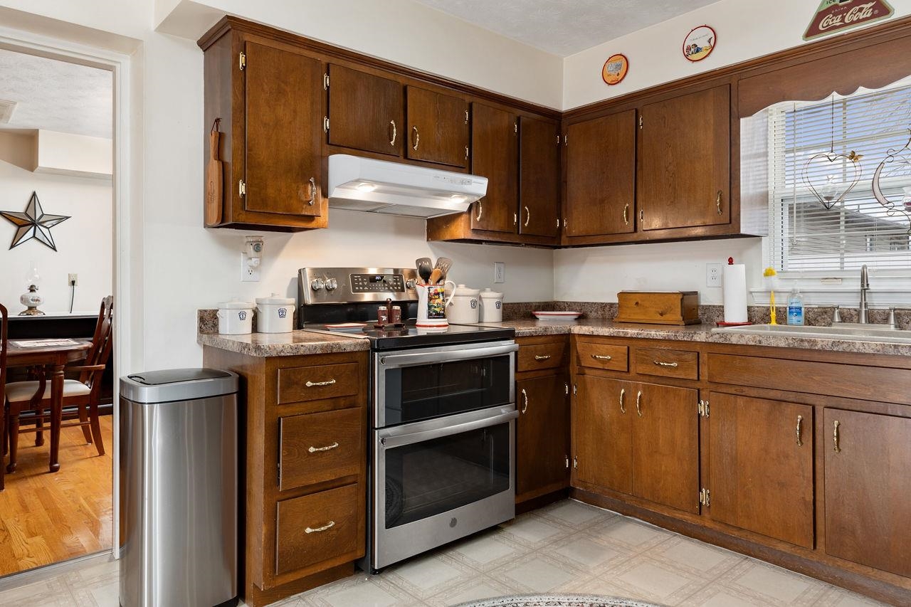 58 Rolla Mill Road Verona, VA 24482 - Photo 28 of 46 a kitchen with stainless steel appliances granite countertop a stove a sink and a microwave