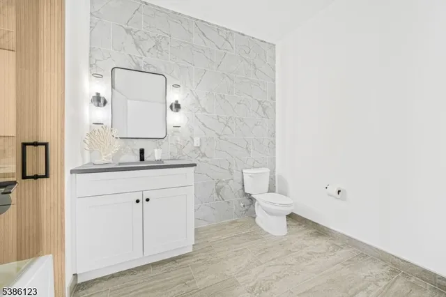 a bathroom with a toilet sink and mirror