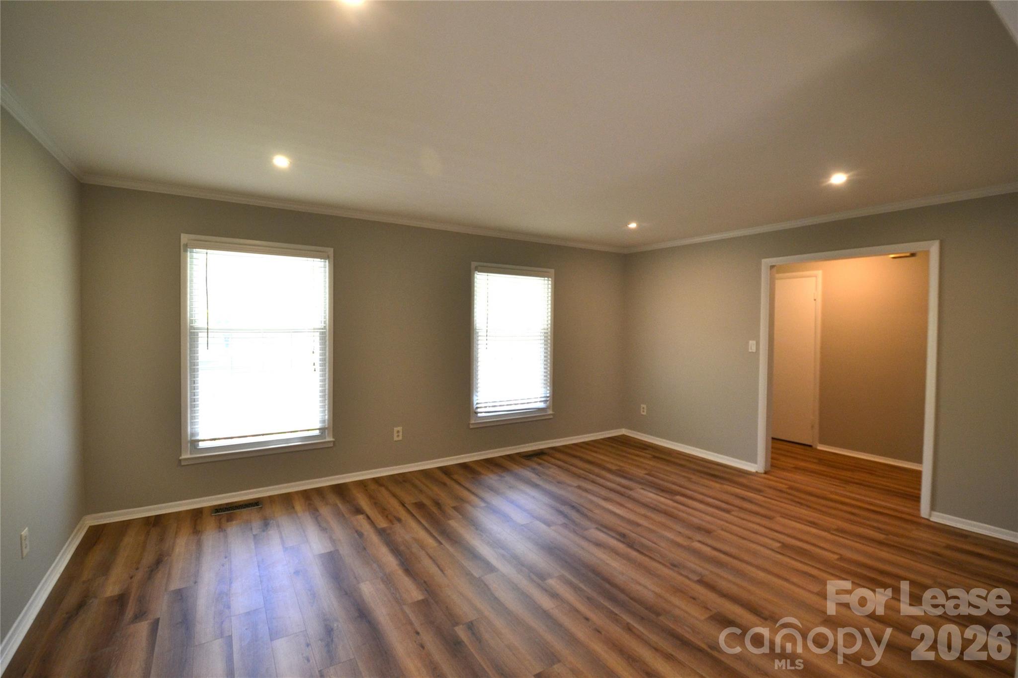 1422 Thermal Road Charlotte, NC 28212 - Photo 3 of 40 an empty room with wooden floor and windows