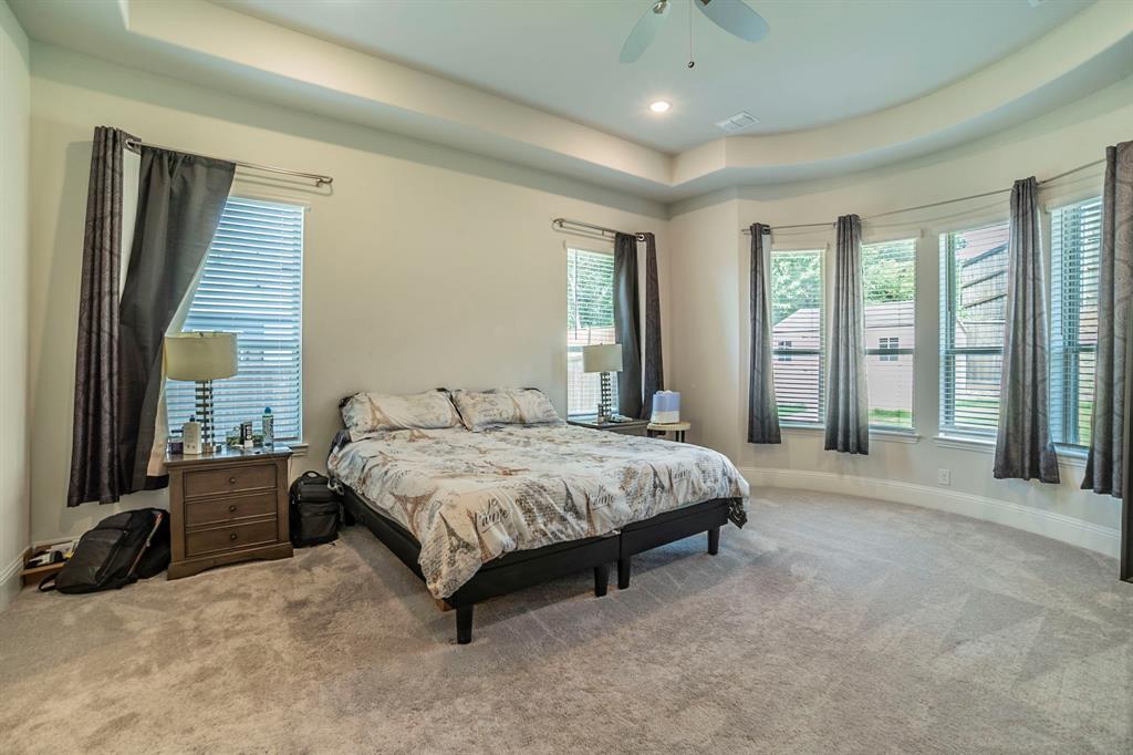 1420 Ashton Ridge Drive Prosper, TX 75078 - Photo 10 of 39 a spacious bedroom with a bed and large windows