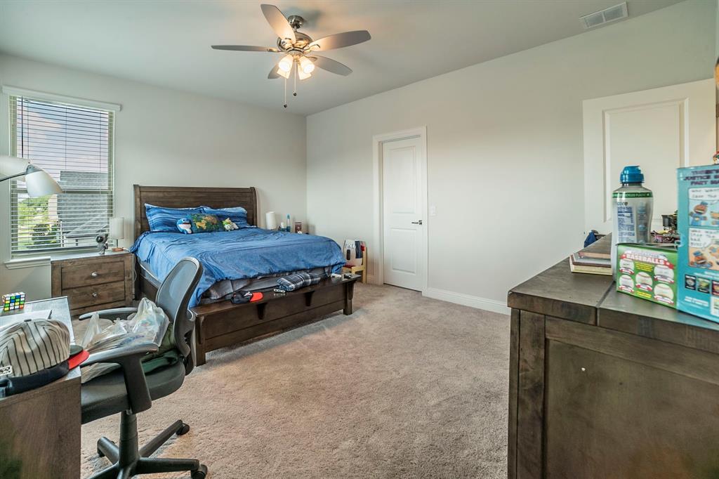 1420 Ashton Ridge Drive Prosper, TX 75078 - Photo 17 of 39 a bedroom with a bed and a desk