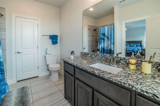 a bedroom with a bed and a desk