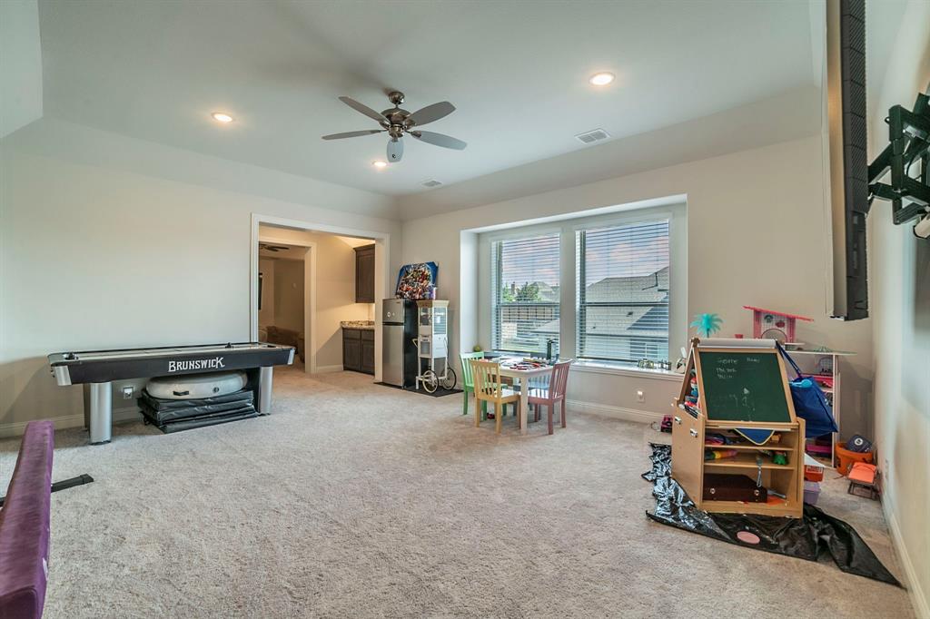 1420 Ashton Ridge Drive Prosper, TX 75078 - Photo 23 of 39 a room with furniture and a flat screen tv