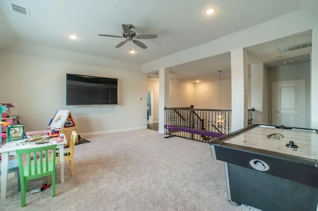 a view of a livingroom with furniture and a flat screen tv
