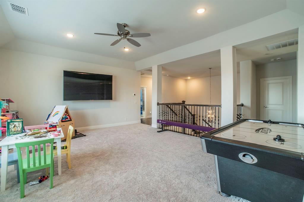 1420 Ashton Ridge Drive Prosper, TX 75078 - Photo 25 of 39 a view of a livingroom with furniture and a flat screen tv