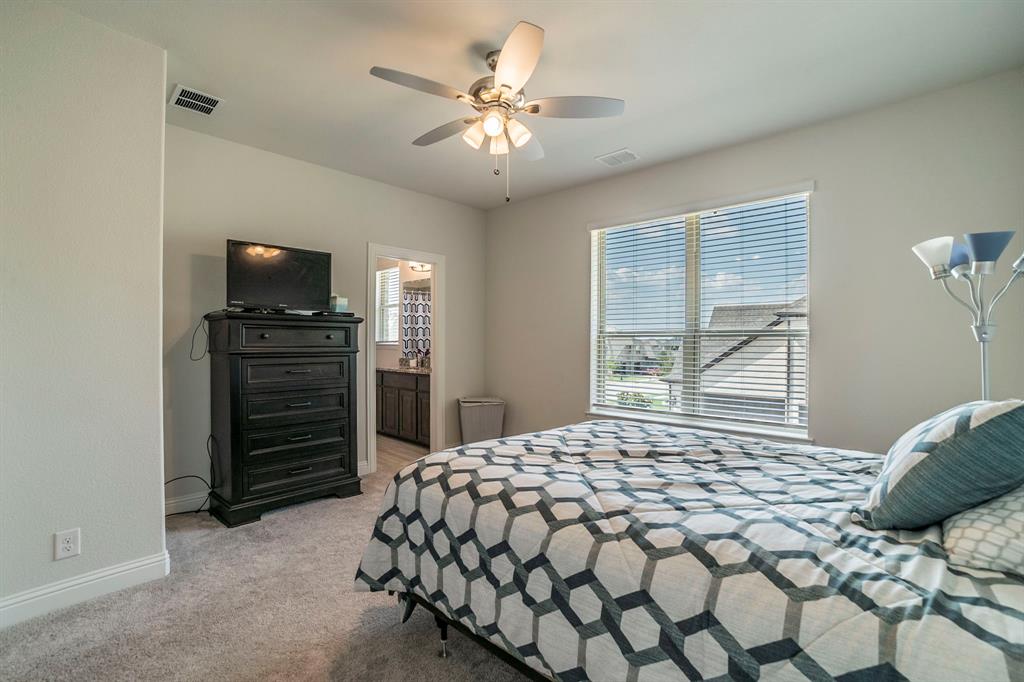 1420 Ashton Ridge Drive Prosper, TX 75078 - Photo 27 of 39 a bedroom with a bed and a television