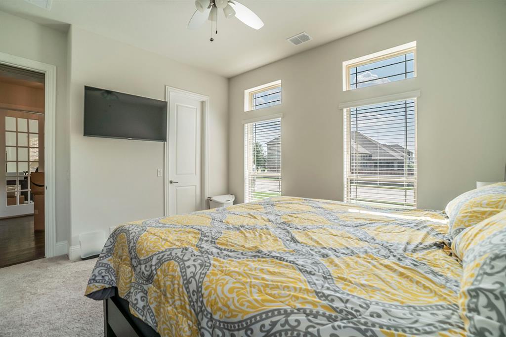 1420 Ashton Ridge Drive Prosper, TX 75078 - Photo 30 of 39 a bedroom with a bed a television and a window