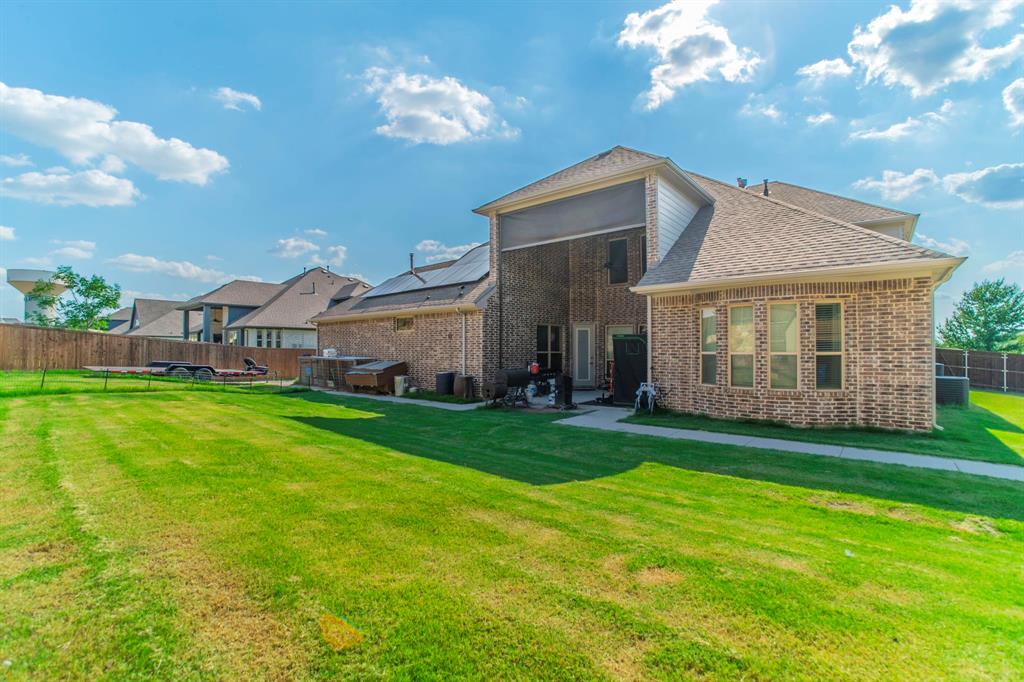 1420 Ashton Ridge Drive Prosper, TX 75078 - Photo 38 of 39 a view of a house next to a big yard with plants and large trees