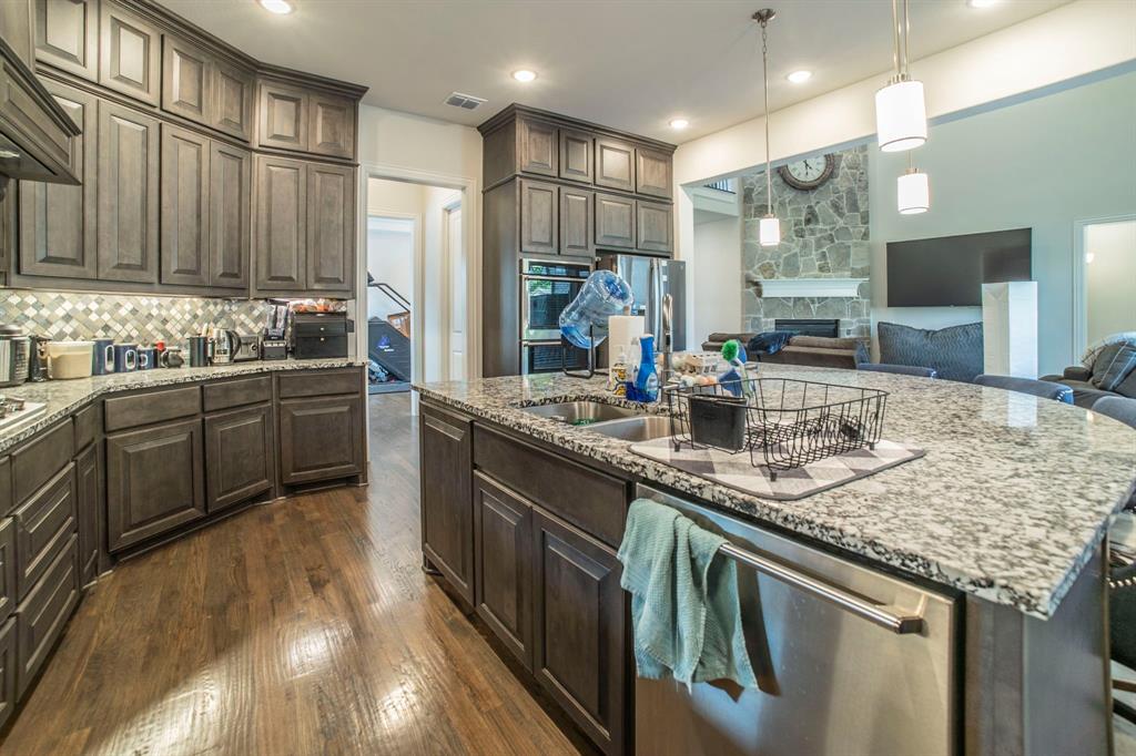 1420 Ashton Ridge Drive Prosper, TX 75078 - Photo 8 of 39 a kitchen with stainless steel appliances granite countertop a sink and a stove