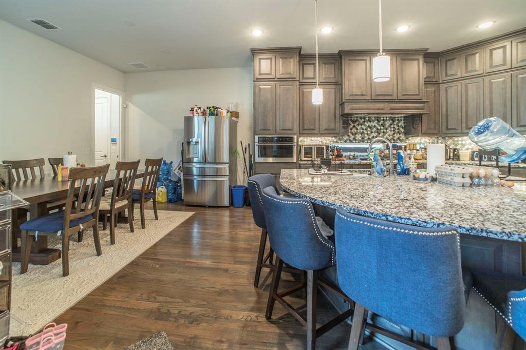 1420 Ashton Ridge Drive Prosper, TX 75078 - Photo 9 of 39 a kitchen with lots of counter space and furniture